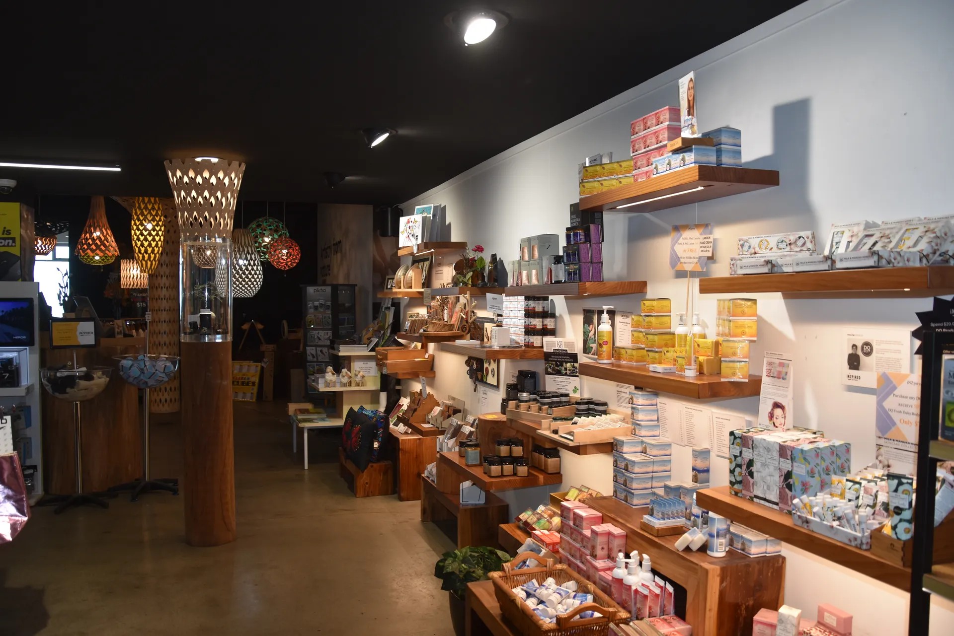 Souvenir store with shelves of beauty products and unique lights in the back.