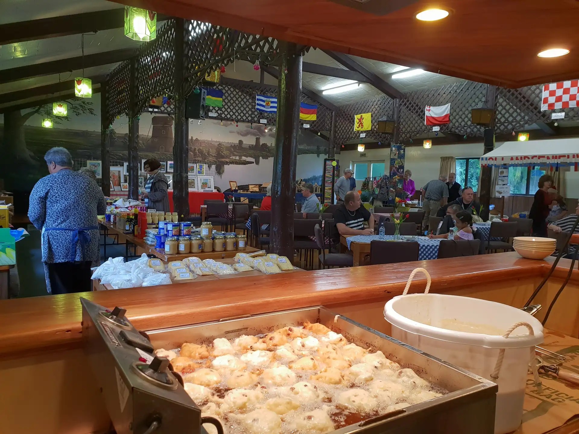Indoor market with Dutch food stalls.