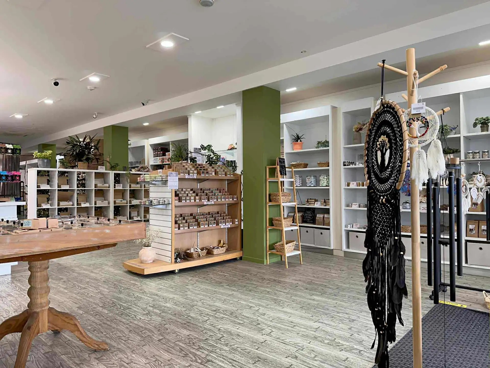 Inside the shop with shelving displays of soap, dreamcatchers and plants.