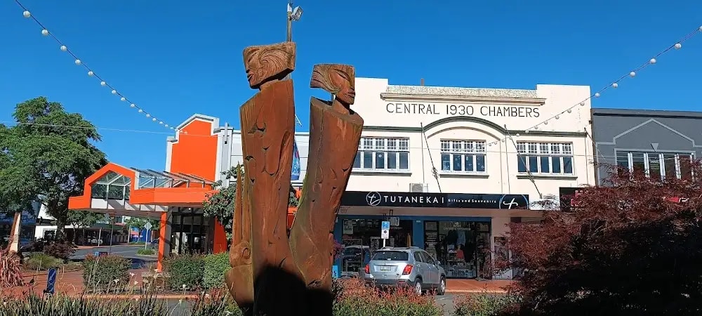 Shot of Tutanekai shop from outside with a Maori cultural statue in the foreground.