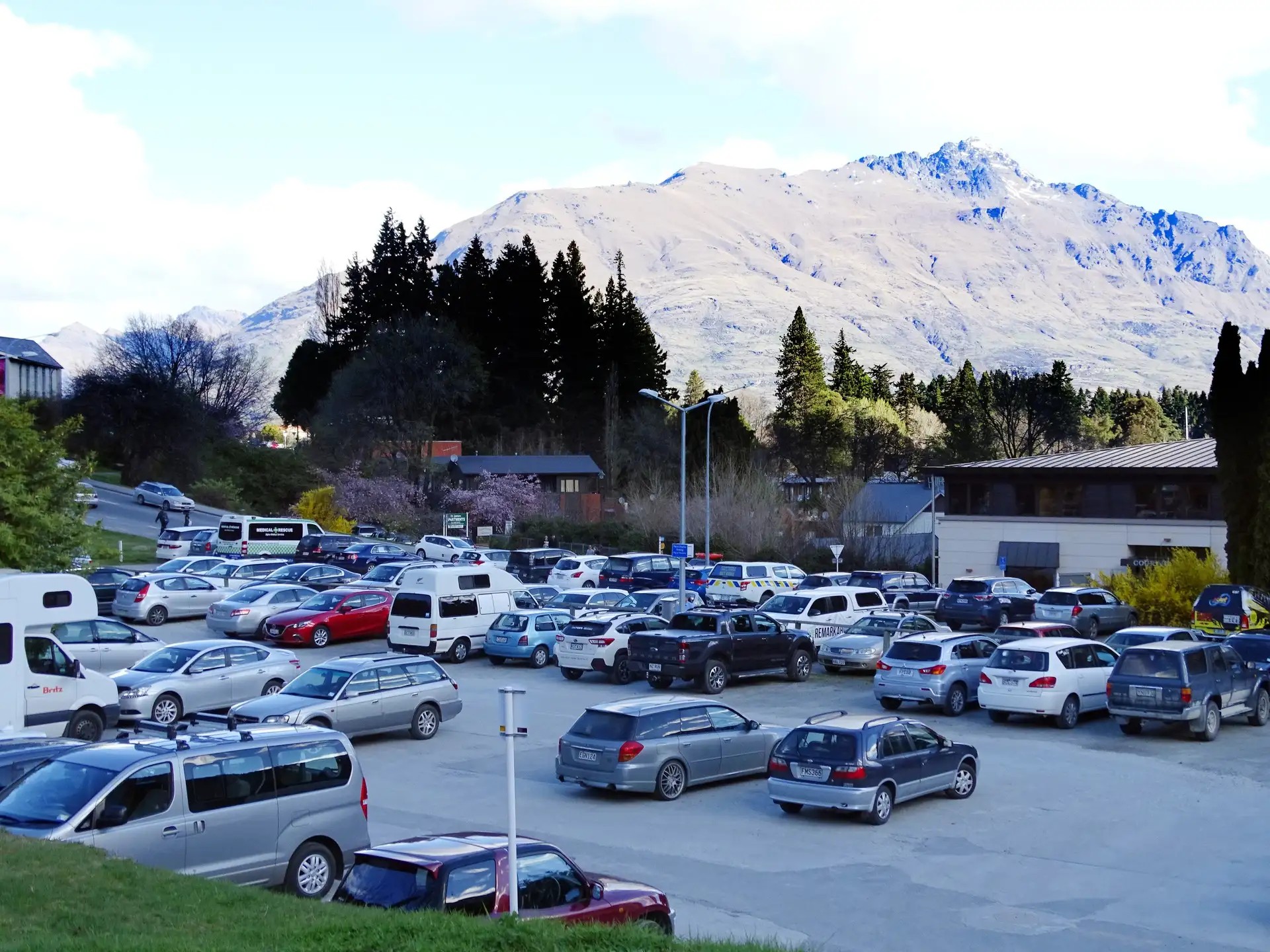 Queenstown public parking lot filled with cars.
