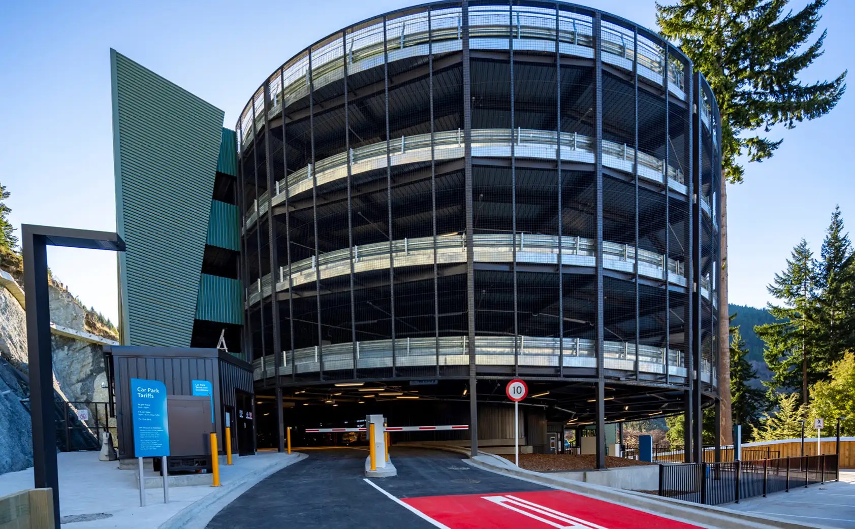 Skyline carparking complex from the entrance POV, with blue skies and green trees in background.