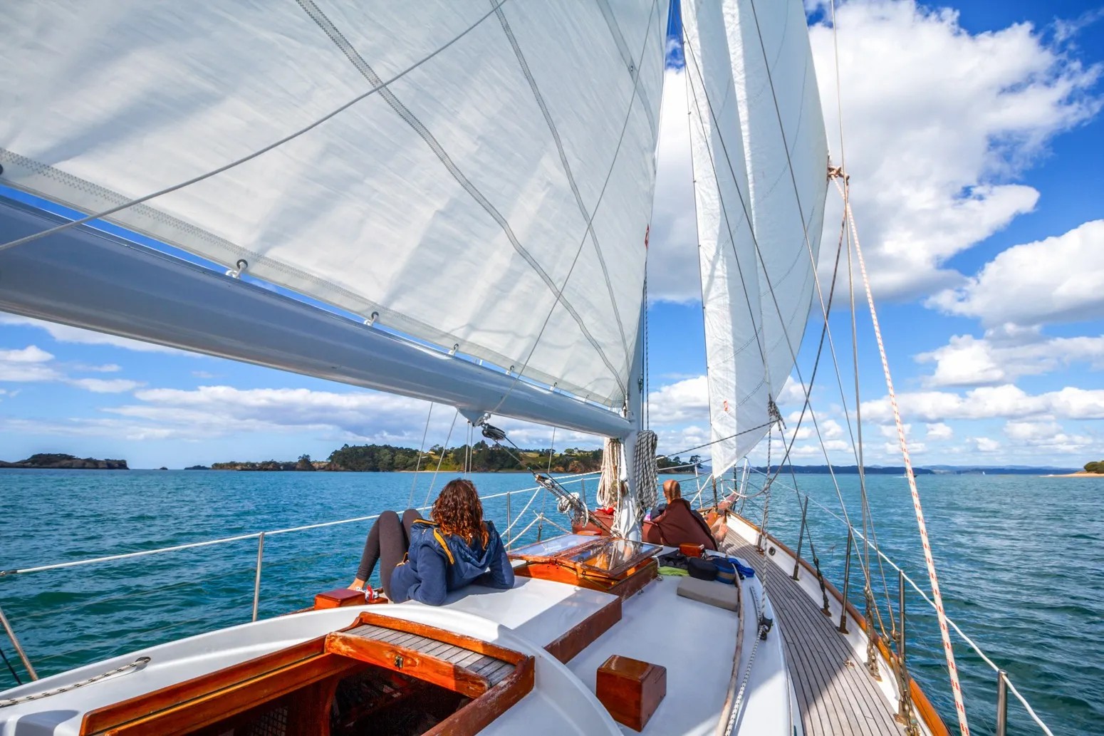 Two people relaxing on a yacht in the sea.