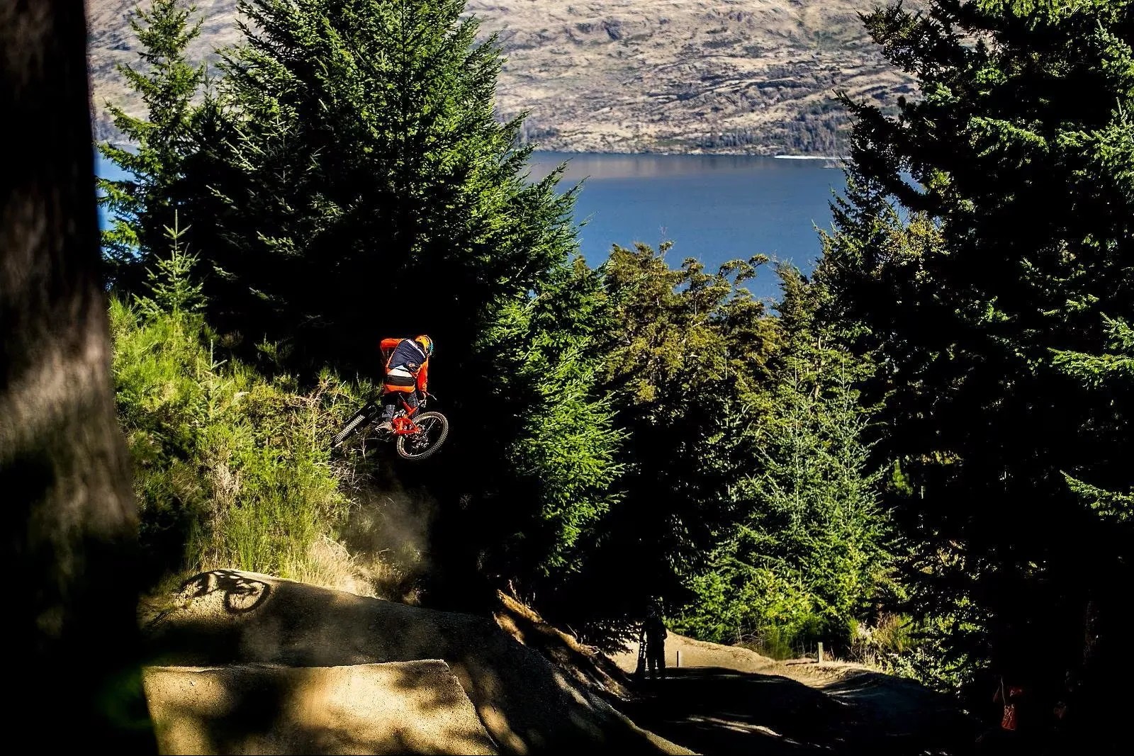 A mountain biker jumping off a ledge in the air.