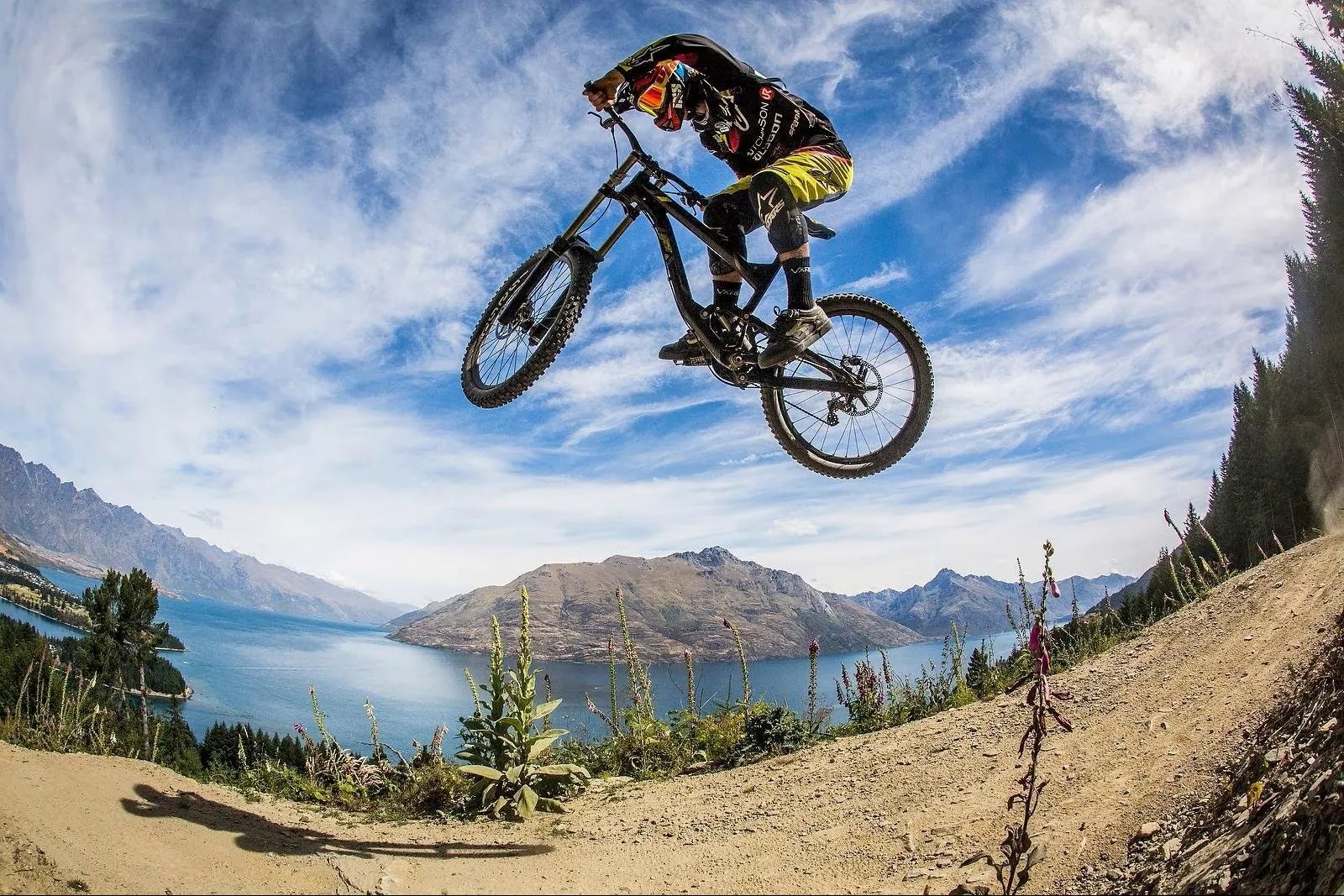 A mountain biker performing a trick in the air.