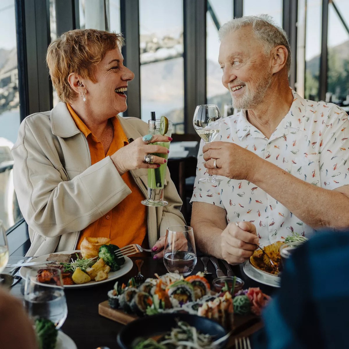 An older couple raises a glass at the Stratosfare Restaurant.