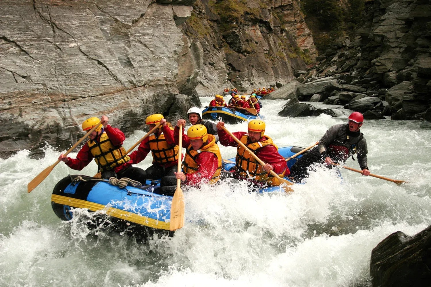 Groups whitewater rafting on the Shotover River.