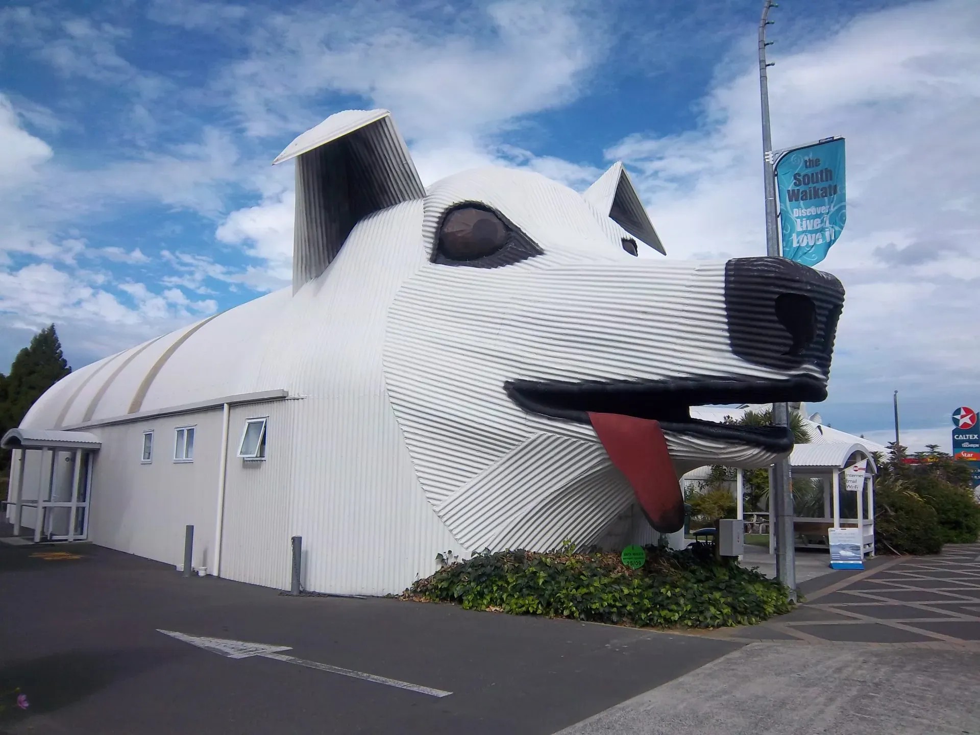 Corrugated iron building shaped like a white dog head.
