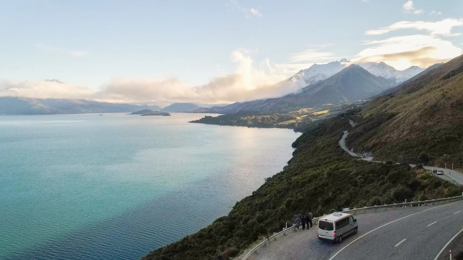 Van stopping at a lookout point along the road from Queenstown to Glenorchy, passing by a large lake.