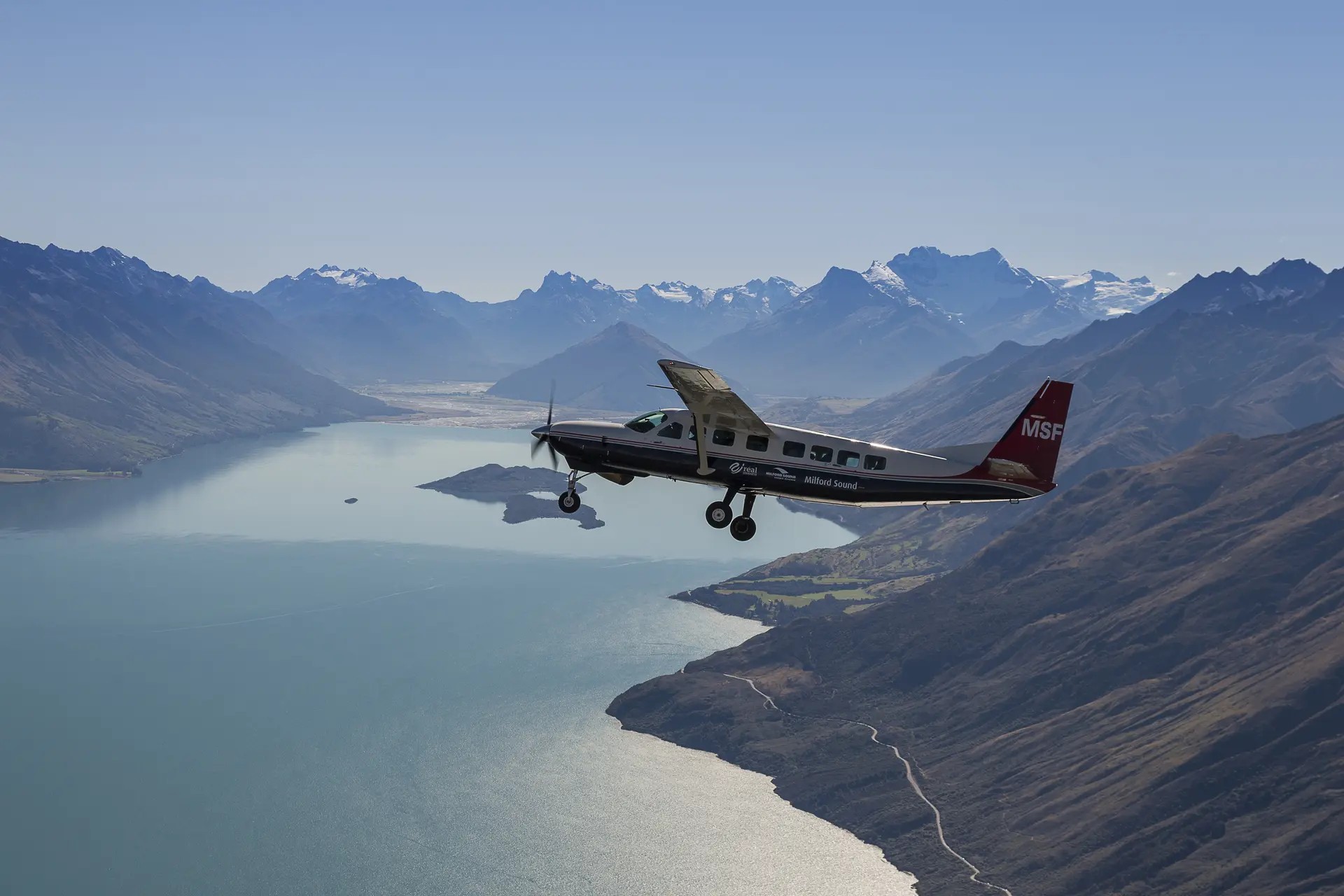 Small plane flying over Milford Sound.