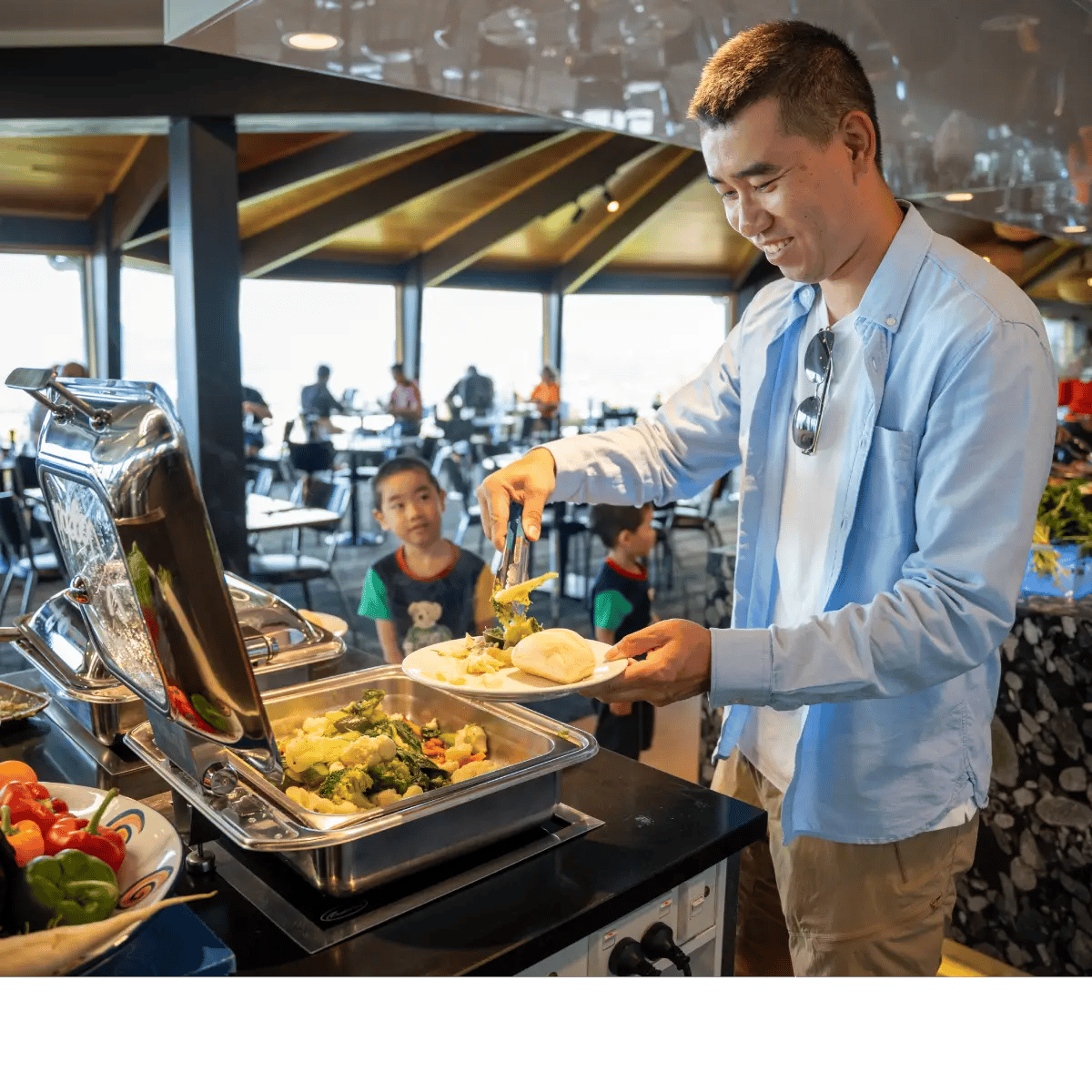 Guest serving food from the buffet at Stratosfare Restaurant during a dining experience at Skyline Rotorua.