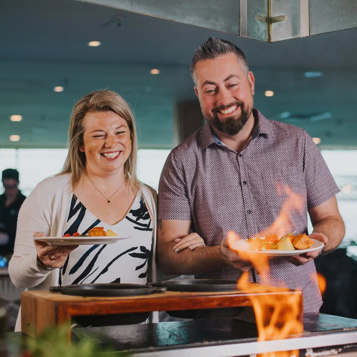 Couple selecting hot food at Skyline Stratosfare Restaurant buffet station