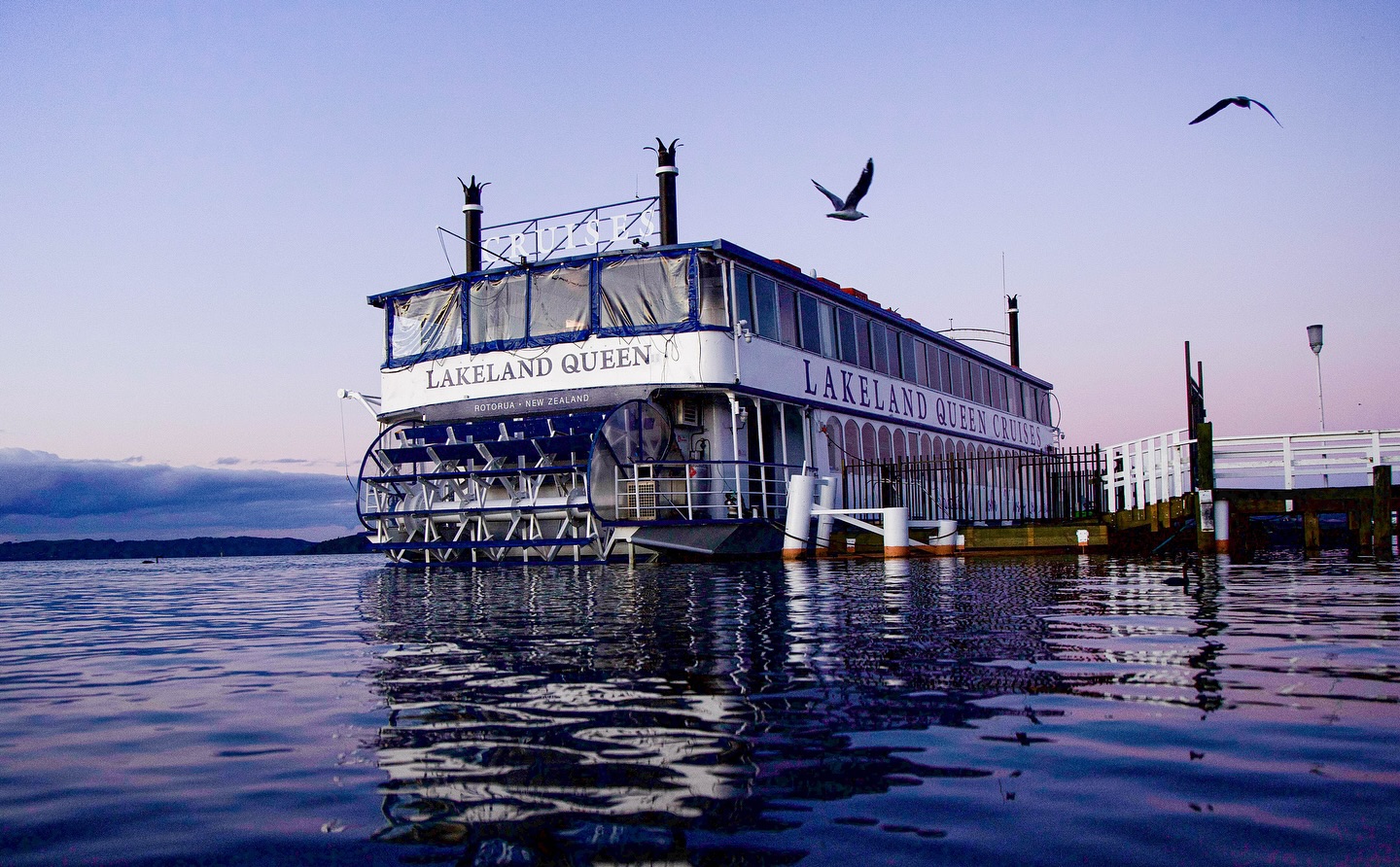 Lakeland Queen cruise boat on on Lake Rotorua at sunset.