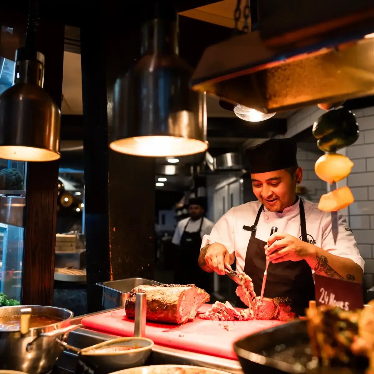 Chef carving roast meat at Skyline Stratosfare Restaurant buffet station