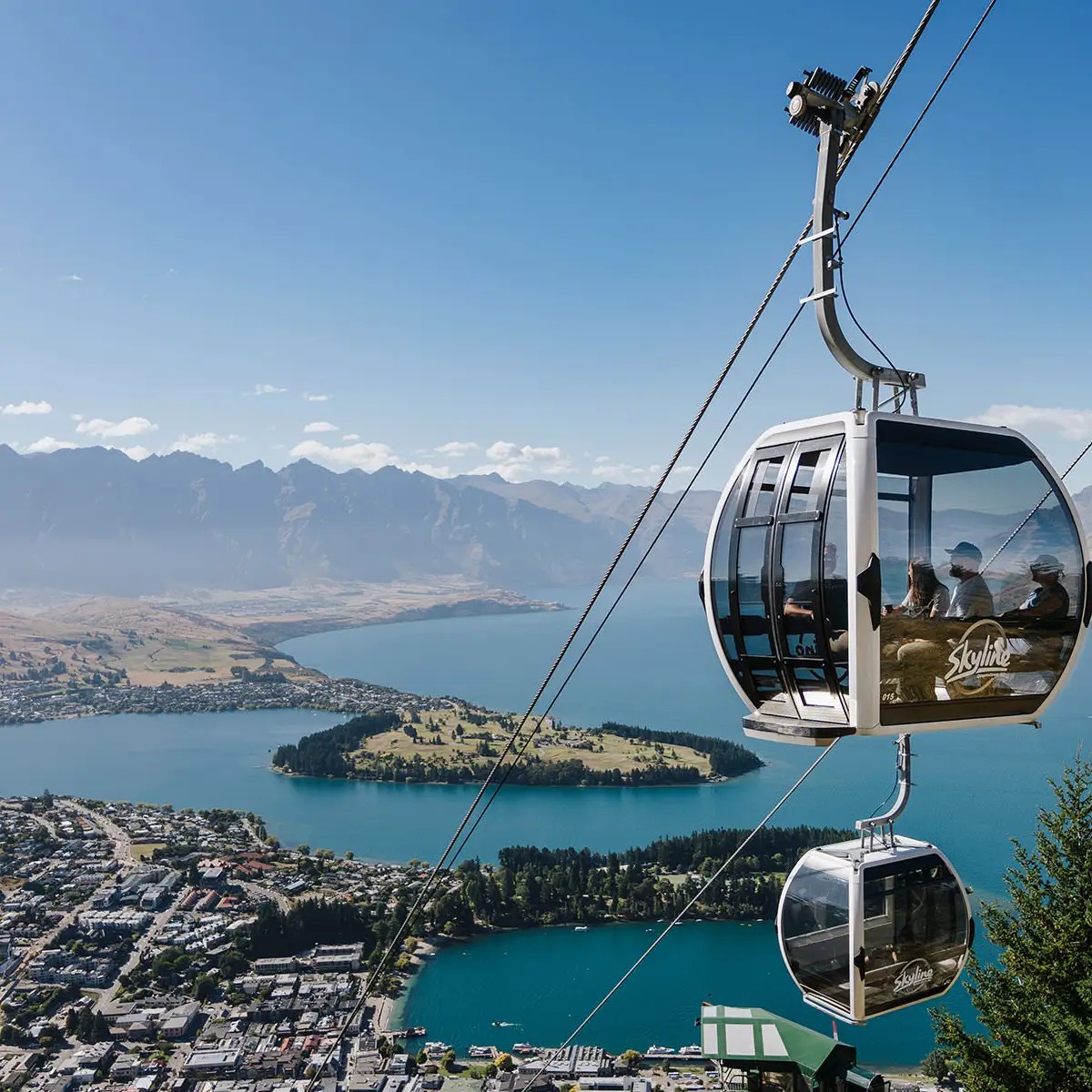 Two Skyline Gondola carriages high above Queenstown and Lake Wakatipu
