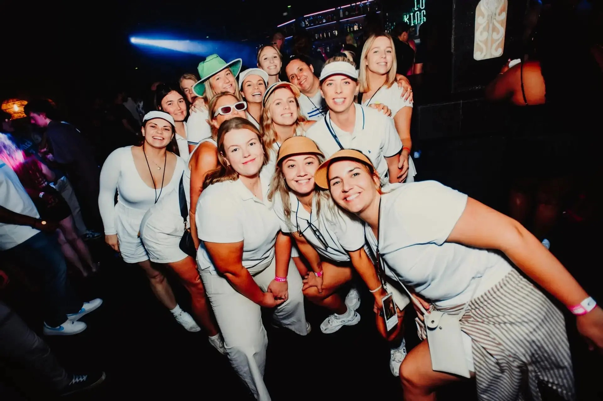 A group of people posing for a photo in a bar.