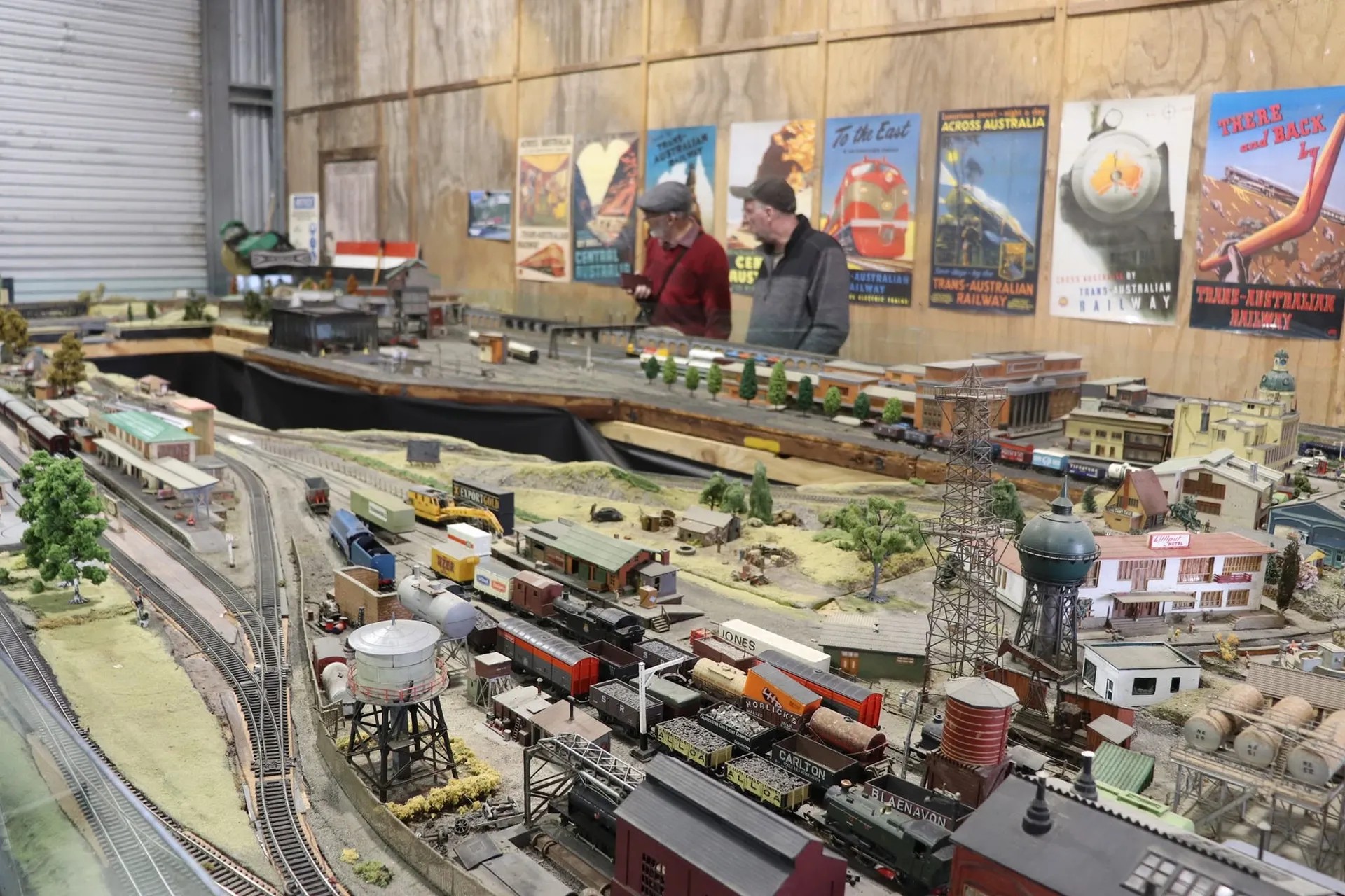 Large miniature train exhibition modeled after a historical mining town. In the back are vintage Australian railway posters.
