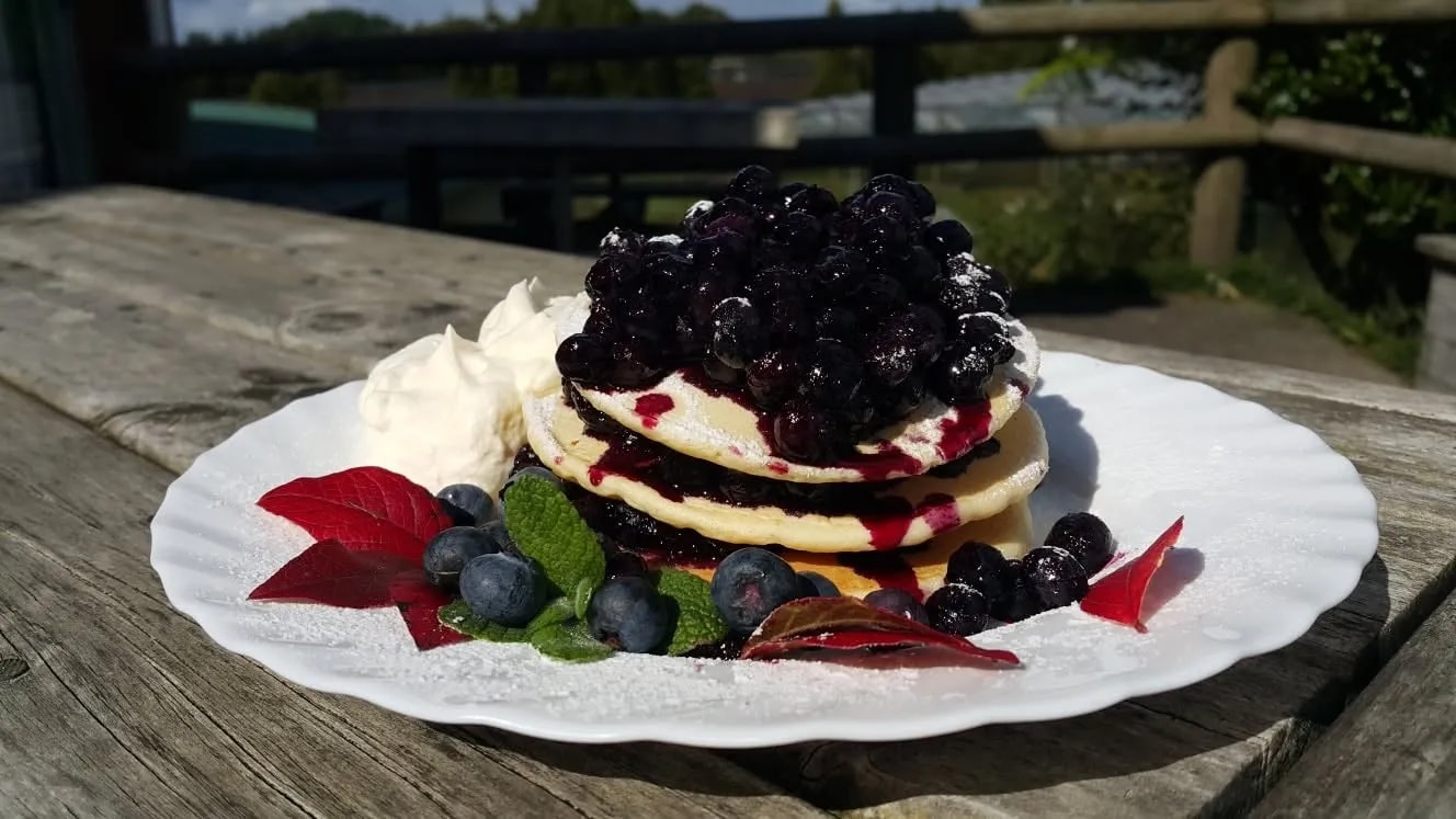 Delicious pancakes with blueberries and cream.