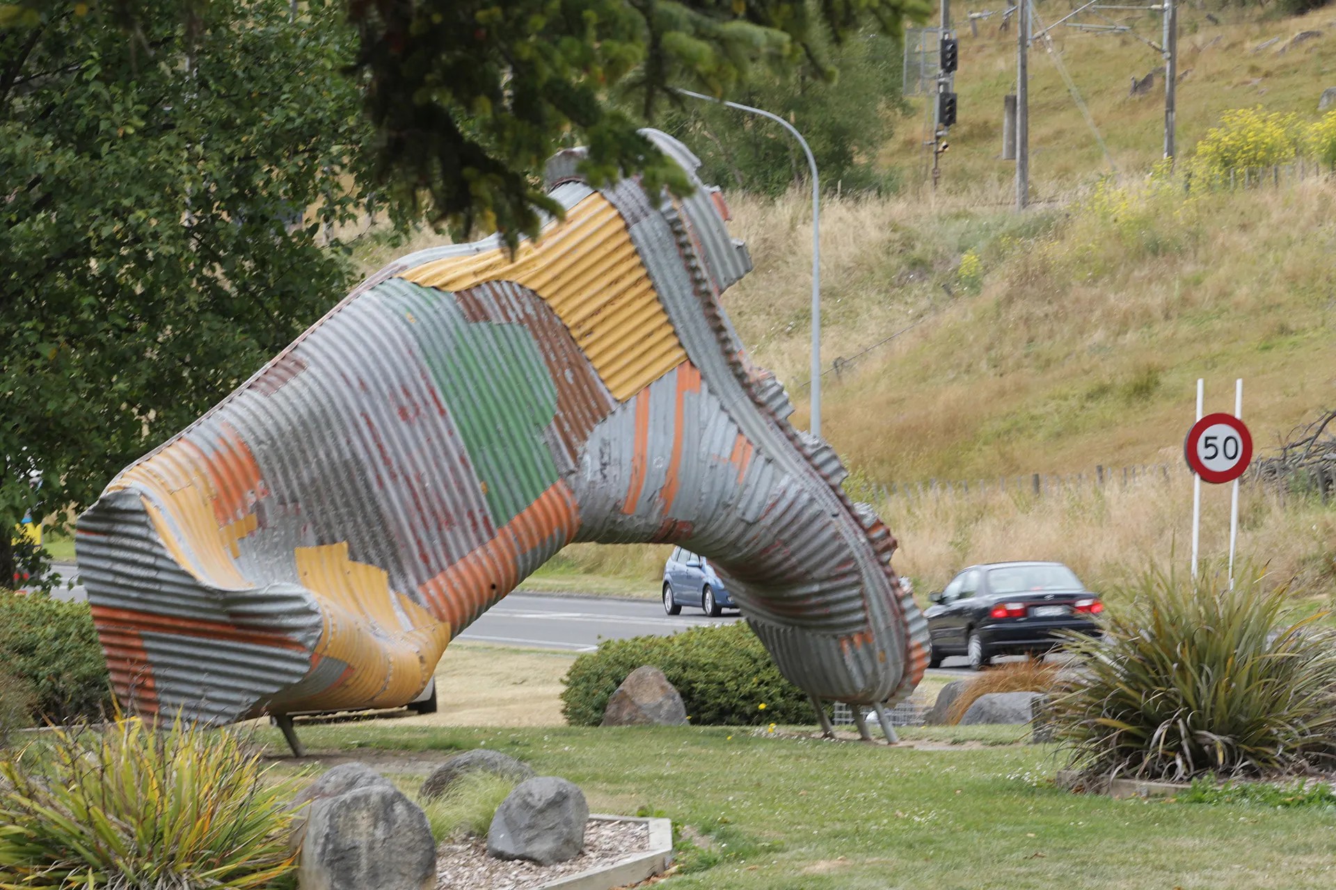 Corrugated iron gumboot sculpture.