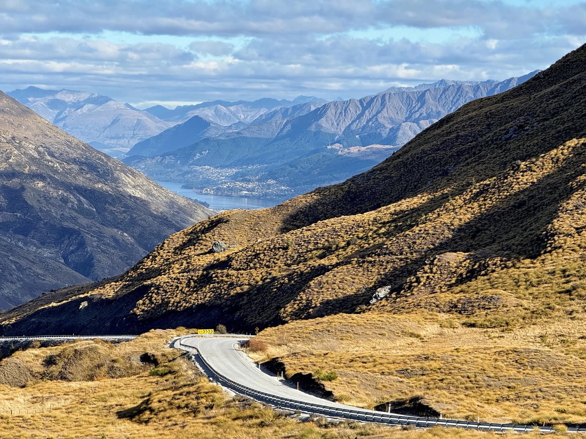 Crown Range Road and surrounding mountains, looking down towards Queenstown and Lake Wakatipu.