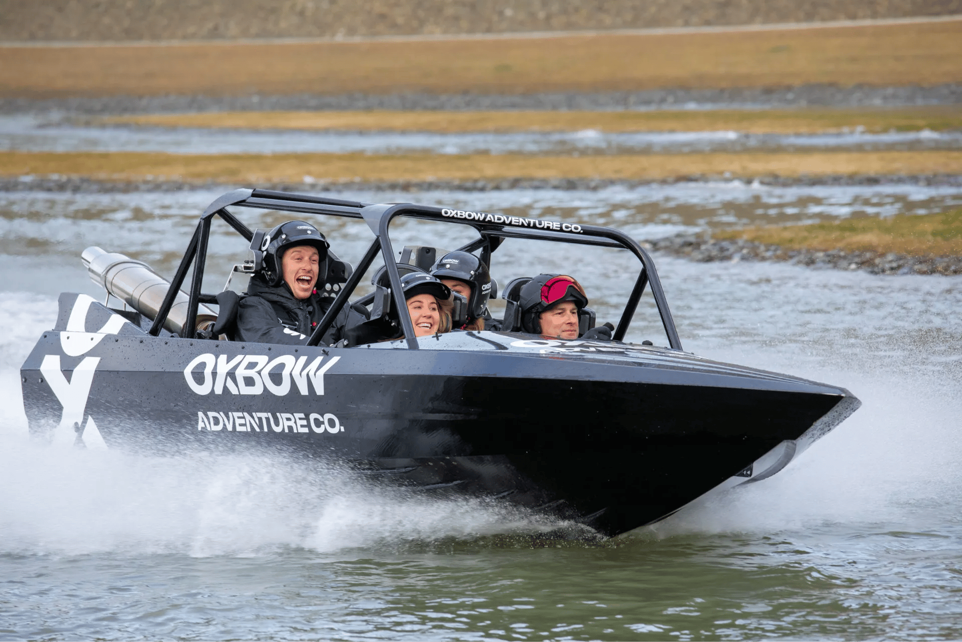 Excited group of people riding a 4-seater jet boat.