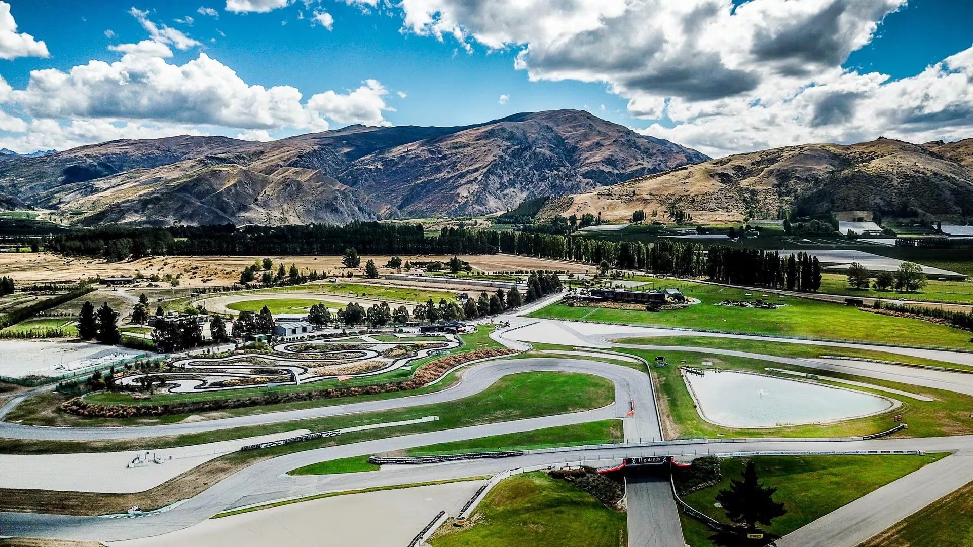Large racing complex with mountain range in background.
