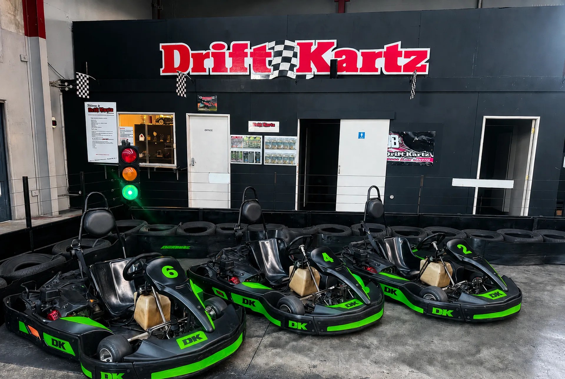 Three go karts under a sign that says Drift Kartz