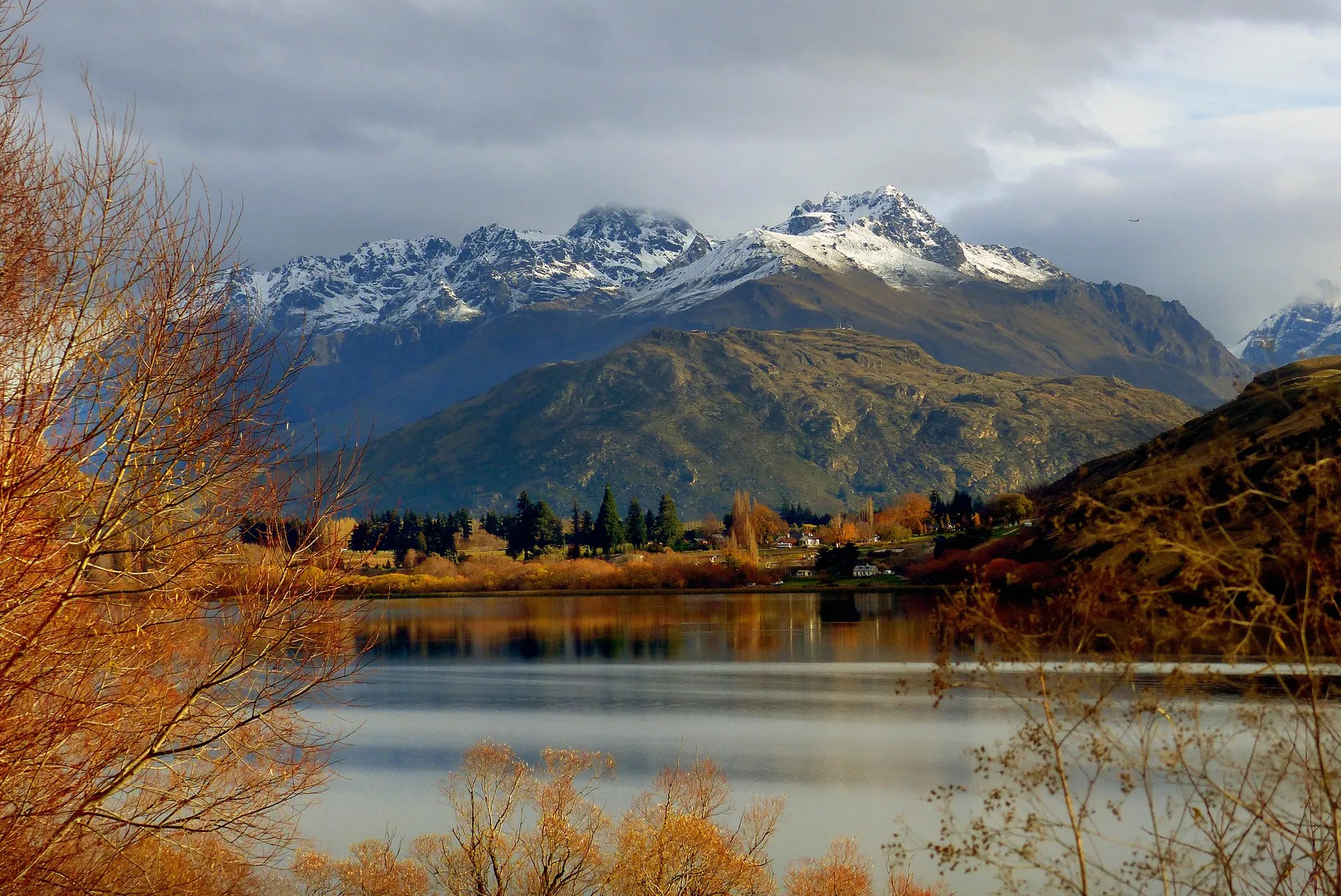 A lake with large snowy mountains in the back