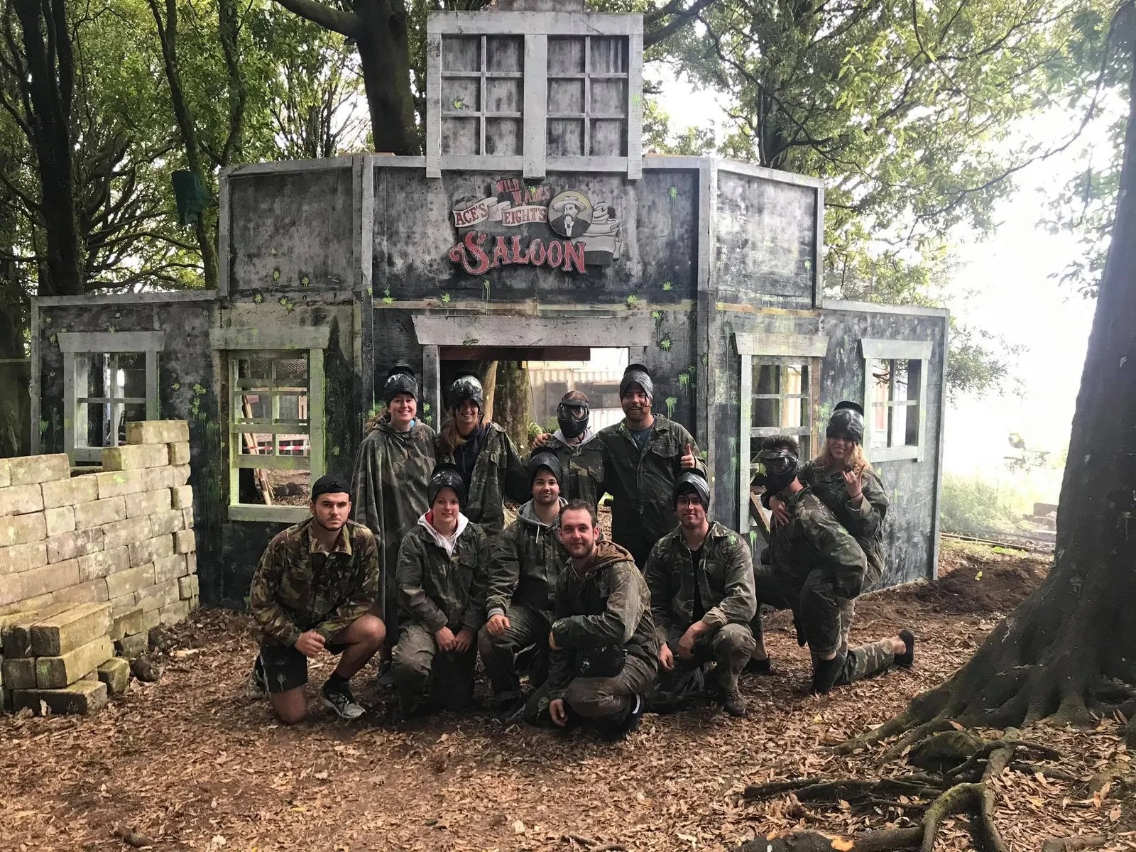 A group of people wearing survival gear in front of a saloon facade