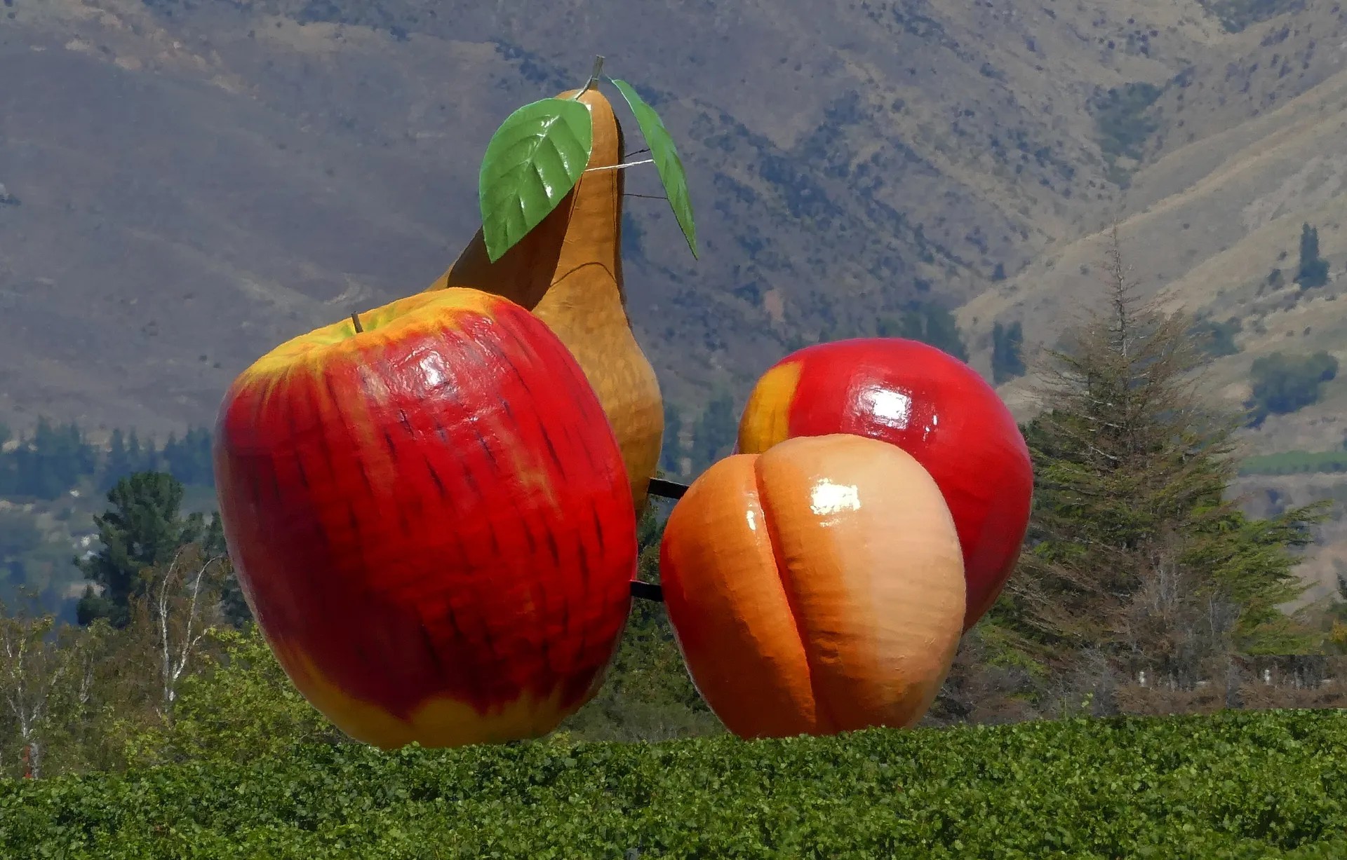 Large sculptures of an apple, pear, and peaches